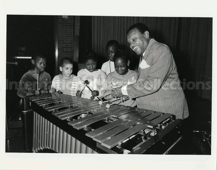 8 x 10 inch photograph. Lionel Hampton playing the vibraphone with a group of children