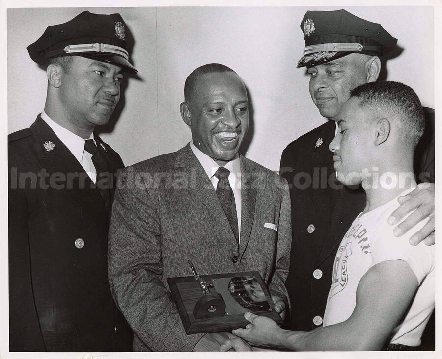8 x 10 inch photograph. Lionel Hampton receives a plaque from the [Philadelphia Police] Athletic League