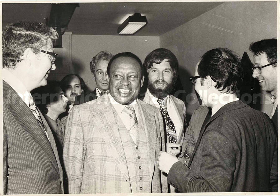 5 x 7 inch photograph. Lionel Hampton leaving a Press Conference. Bill Titone is seen in the background. Montevideo, [Uruguay]