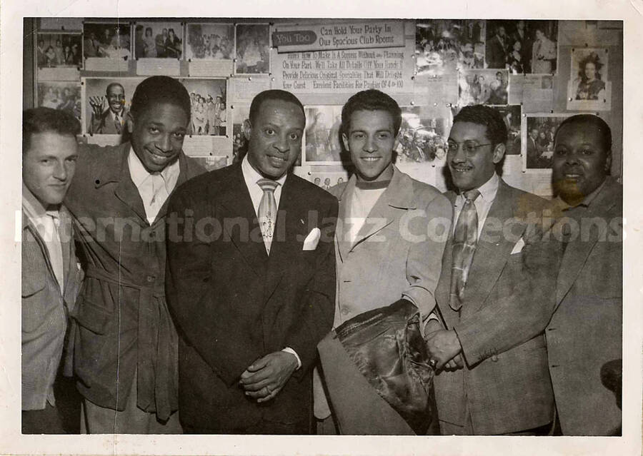 5 x 7 inch photograph. Lionel Hampton with unidentified men, in a club