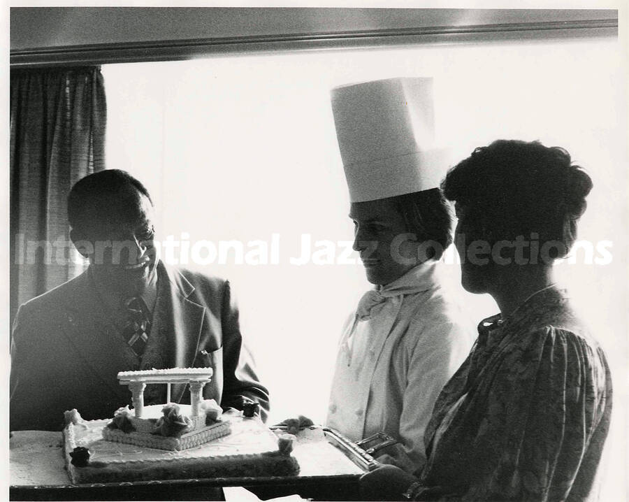 8 x 10 inch photograph. Lionel Hampton presented with a [birthday?] cake by a chef