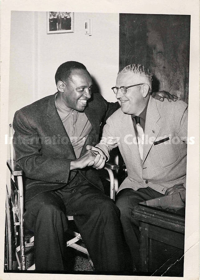7 x 5 inch photograph. Lionel Hampton on wheel chair with unidentified man