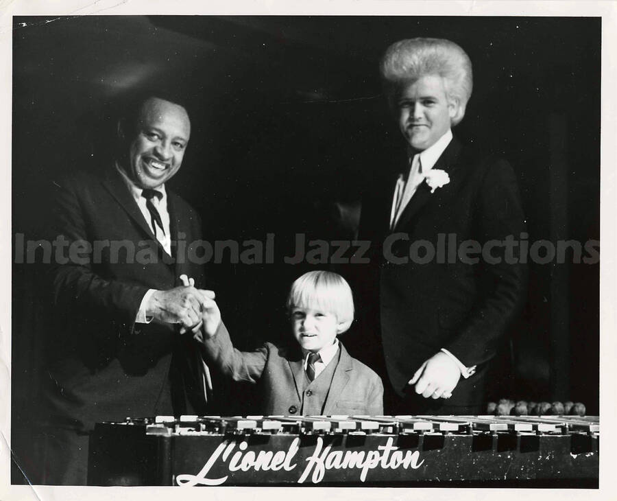 8 x 10 inch photograph. Lionel Hampton with unidentified man and boy