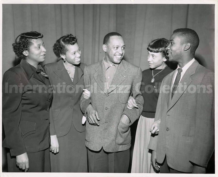 8 x 10 inch photograph. Lionel Hampton with three unidentified women and a man