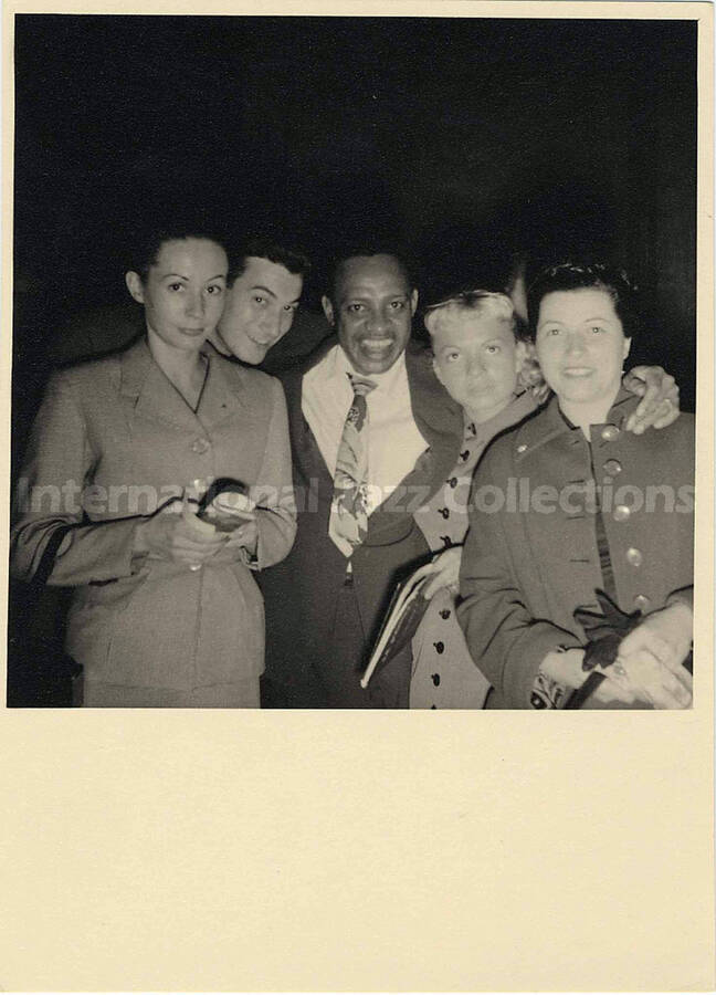 7 x 5 inch photograph. Lionel Hampton with unidentified persons, in Paris, France