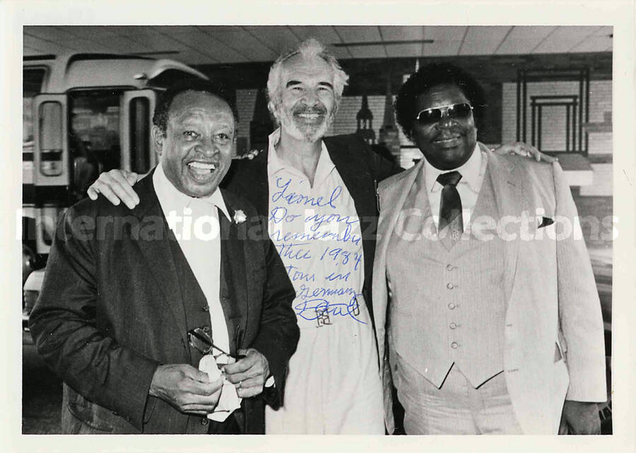 5 x 7 inch photograph. Lionel Hampton, Dave Brubeck, and an unidentified man, in Germany. This photograph has a dedication to Hampton from Dave