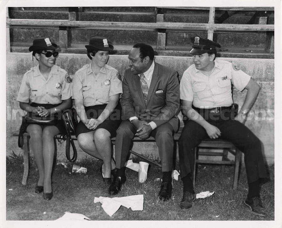 8 x 10 inch photograph. Lionel Hampton with three unidentified police officers