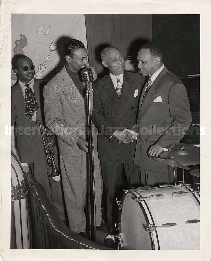 10 x 8 inch photograph. Lionel Hampton with three unidentified men