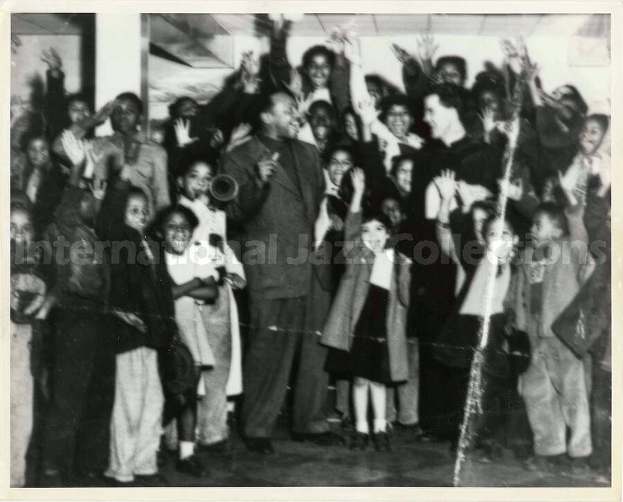 8 x 10 inch photograph. Lionel Hampton with unidentified religious person surrounded by children