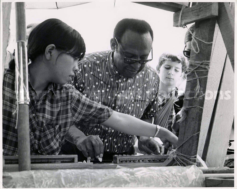 8 x 10 inch photograph. Lionel Hampton in Thailand. Typewritten note on the back of the photograph reads: Lionel Hampton picks at a Japanese-style samisan during a visit to Bangkok's Sunday Market. Mr. Hampton, who is touring Thailand with his Jazz Inner Circle, has been appointed Ambassador of Good Will by President Richard Nixon