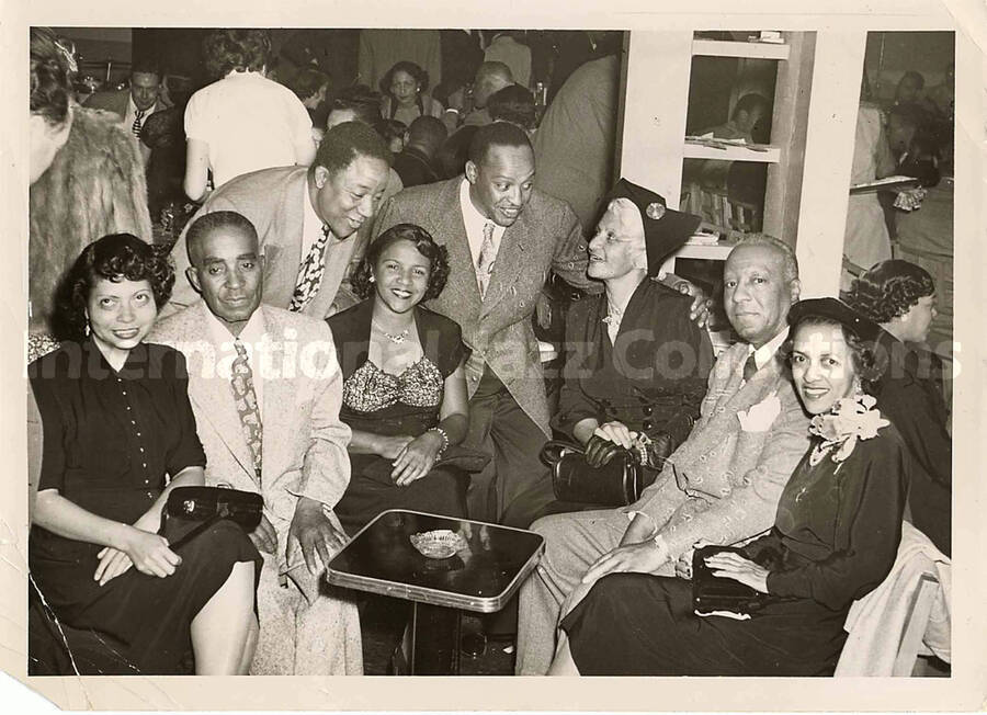 5 x 7 inch photograph. Lionel Hampton with unidentified persons in a tavern