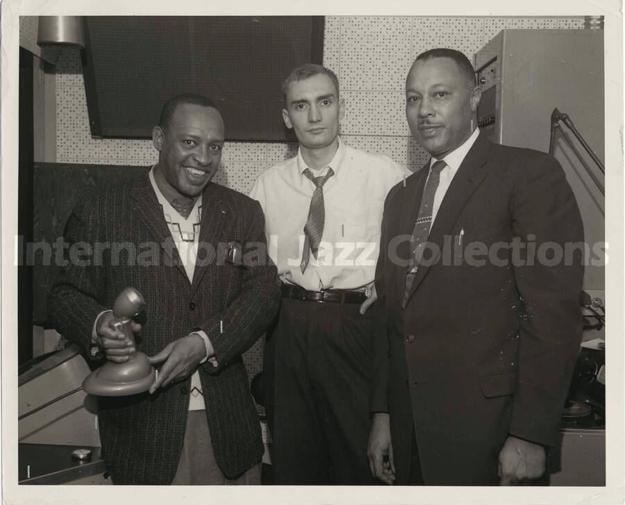 8 x 10 inch photograph. Lionel Hampton with two unidentified men in a recording studio
