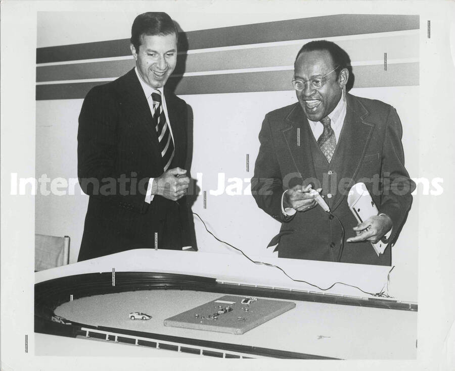 8 x 10 inch photograph. Lionel Hampton and unidentified man play a racing game [at the Aurora Super Fair' 74]