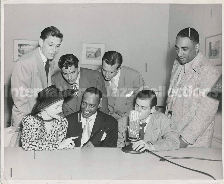 8 x 10 inch photograph. Lionel Hampton with five unidentified men and a woman at the NBC studio