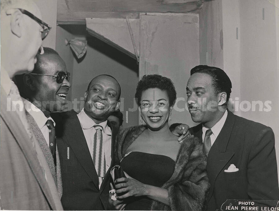 7 x 9 1/2 inch photograph. Lionel Hampton with unidentified persons