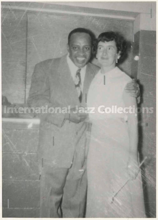 4 3/4 x 3 1/2 inch photograph. Lionel Hampton with unidentified woman [in Canada?]