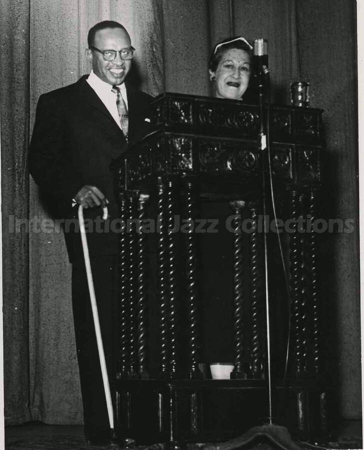5 x 3 1/2 inch photograph. Lionel Hampton poses with a member of the Los Angeles Chapter of Hadassah, on the occasion of his being awarded the certificate of the Hadassah Vocational Education Scholarship for his devotion to the State of Israel. Los Angeles, CA