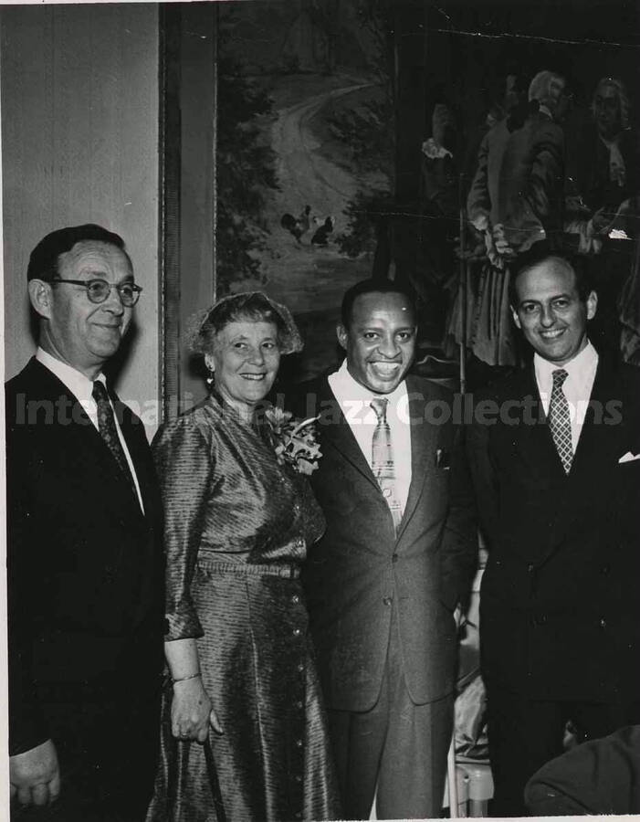 5 x 3 1/2 inch photograph. Lionel Hampton poses with members of the Los Angeles Chapter of Hadassah, on the occasion of his being awarded the certificate of the Hadassah Vocational Education Scholarship for his devotion to the State of Israel. Los Angeles, CA