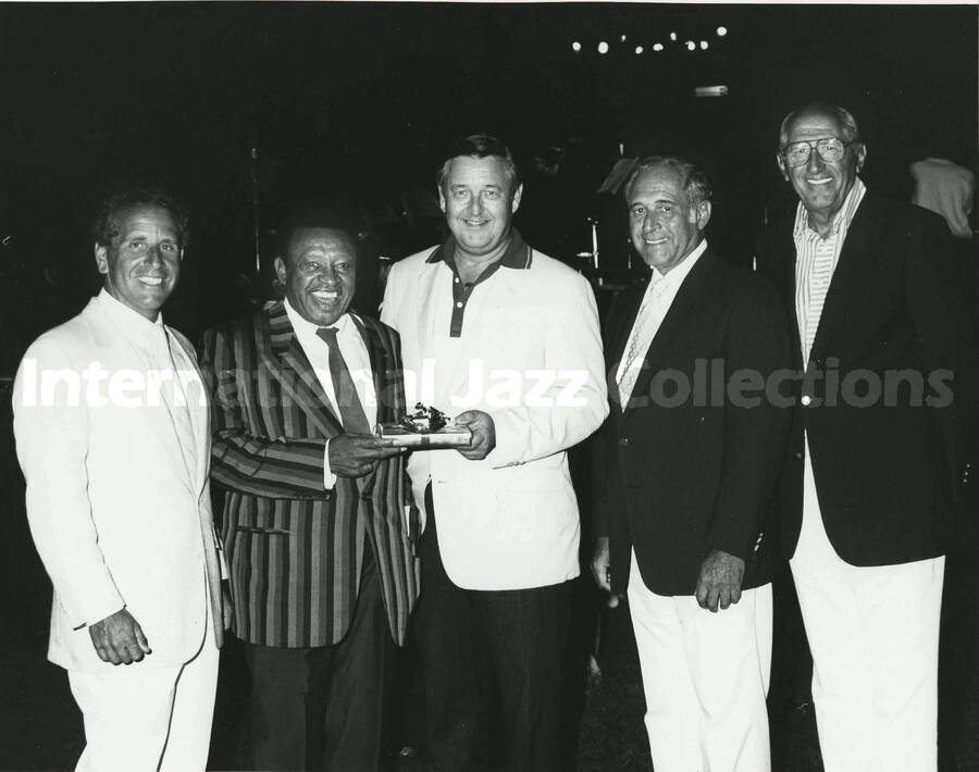 8 x 10 inch photograph. Lionel Hampton with unidentified men