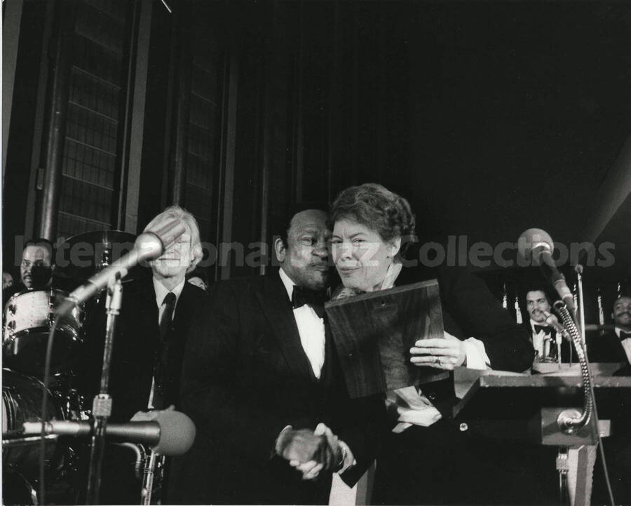 8 x 10 inch photograph. Lionel Hampton receiving from Jeane Jordan Kirkpatrick a plaque from the United States Mission that appointed him as Ambassador of Music to the United Nations