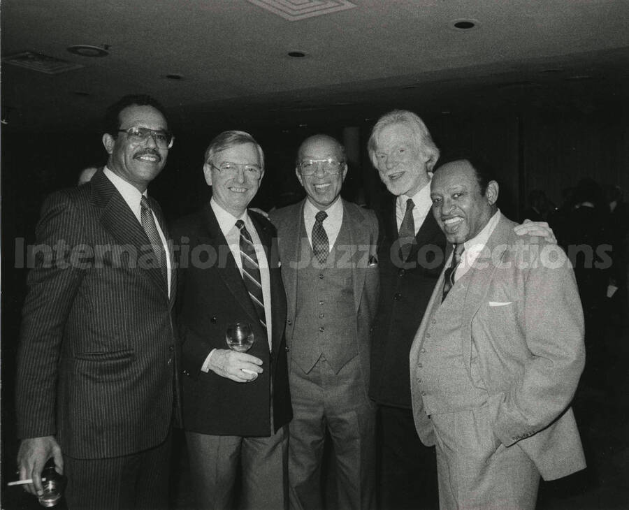 8 x 10 inch photograph. Lionel Hampton with Gerry Mulligan and three unidentified men, on the occasion of his receiving a plaque from the United States Mission that appointed him as Ambassador of Music to the United Nations