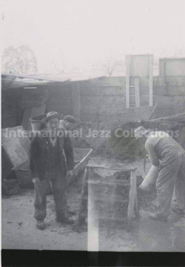 4 1/2 x 3 1/4 inch photograph. Unidentified men working in a pit