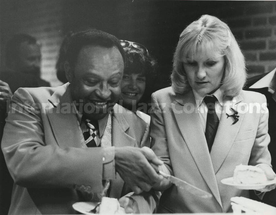 8 x 10 inch photograph. Lionel Hampton with a slice of [birthday?] cake