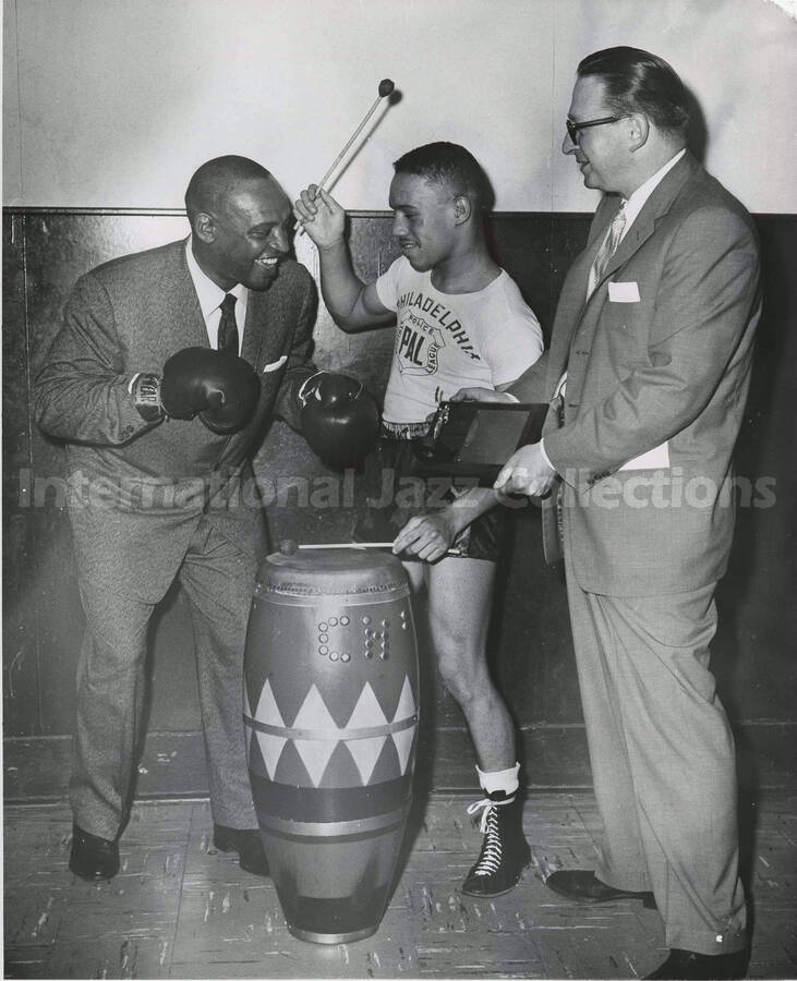 10 x 8 inch photograph. Lionel Hampton poses with unidentified men, on the occasion  his receiving a plaque from the [Philadelphia Police] Athletic League