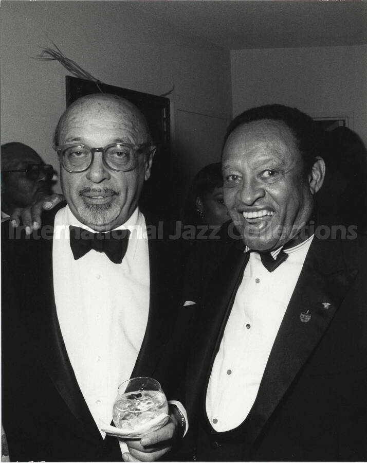 10 x 8 inch photograph. Lionel Hampton with unidentified man at a reception