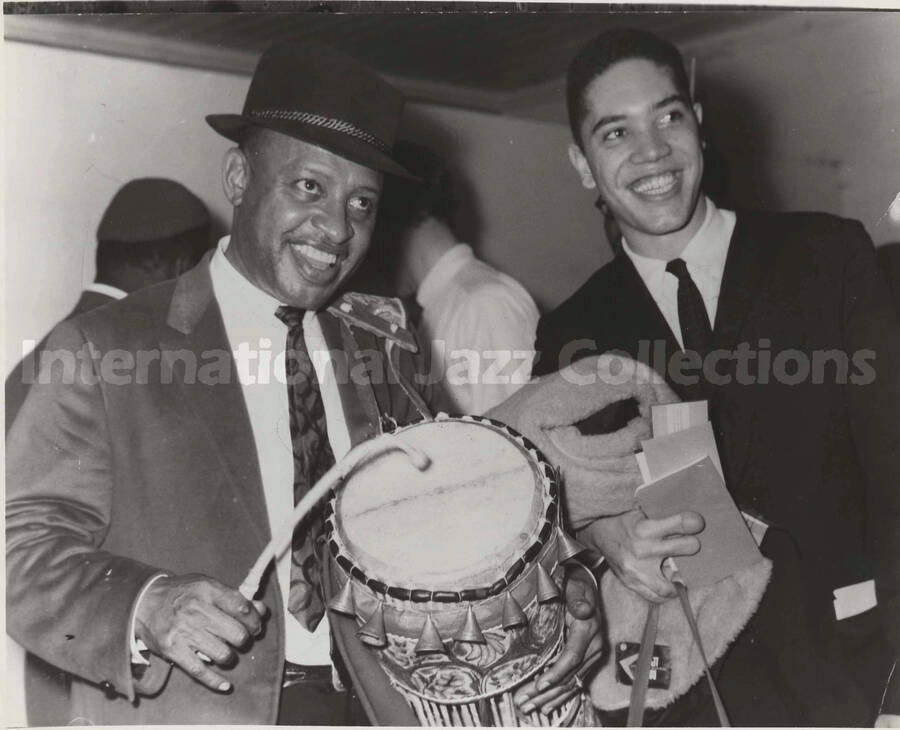 8 x 10 inch photograph. Lionel Hampton with unidentified man, probably in an airport terminal of an African country