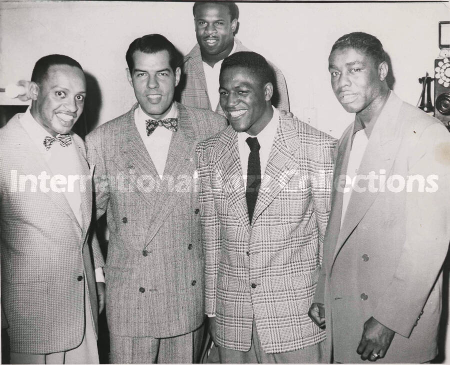 8 x 10 inch photograph. Lionel Hampton with four unidentified men