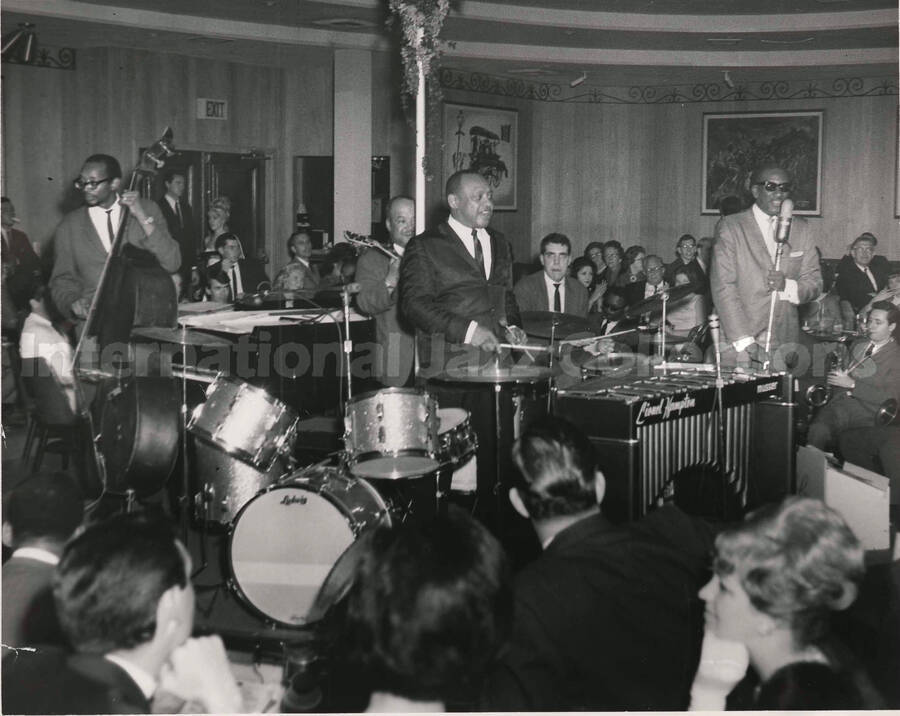 8 x 10 inch photograph. Lionel Hampton performing with band, which includes guitarist Billy Mackel