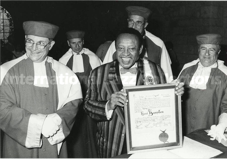 5 1/2 x 8 inch photograph. Lionel Hampton on the occasion of his receiving a certificate [in France?]