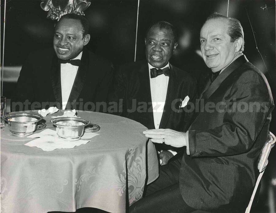 8 x 10 inch photograph. Lionel Hampton with Louis Armstrong and Joey Adams
