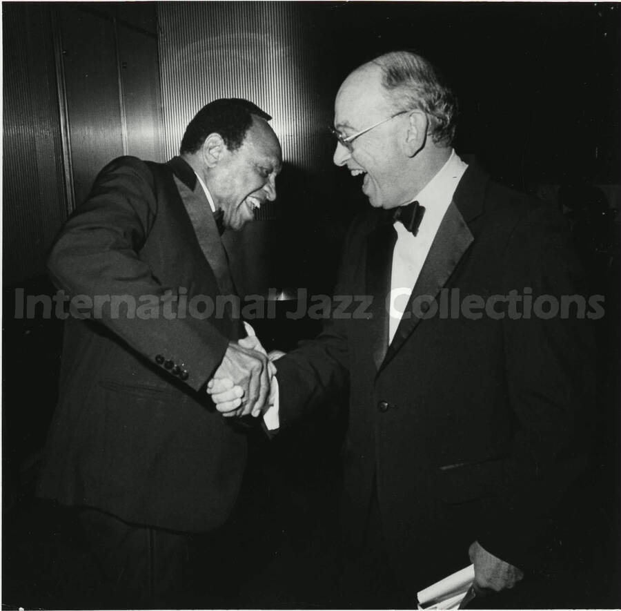 8 x 10 inch photograph. Lionel Hampton with unidentified man on the occasion of his receiving the Lifetime Achievement Award of B'nai B'rith, at the Sheraton Centre in New York