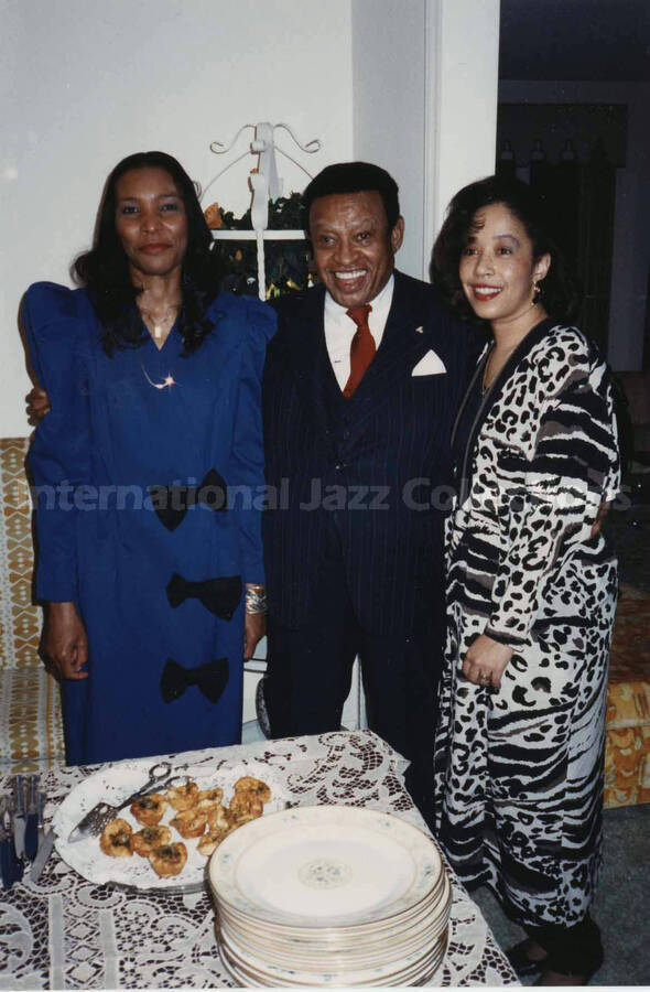 4 x 6 inch photograph. Lionel Hampton with L. Gordon and Charlene Price Patterson at the Webber residence, in Charlotte, N.C.