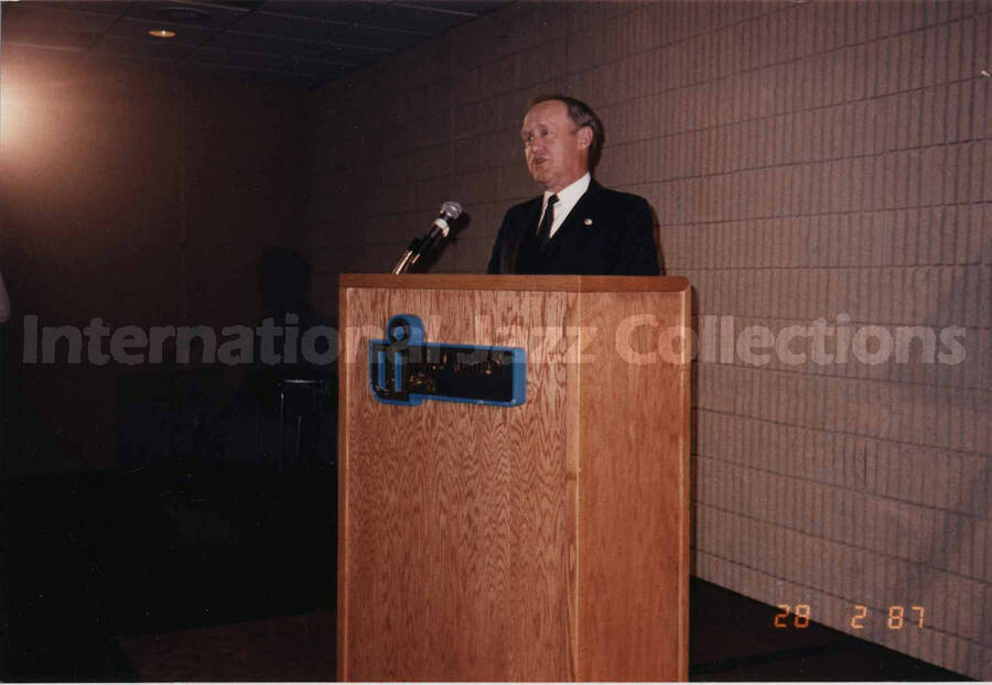 4 x 6 inch photograph. Unidentified man on podium on the occasion of the dedication of the Lionel Hampton School of Music. University of Idaho, Moscow, ID