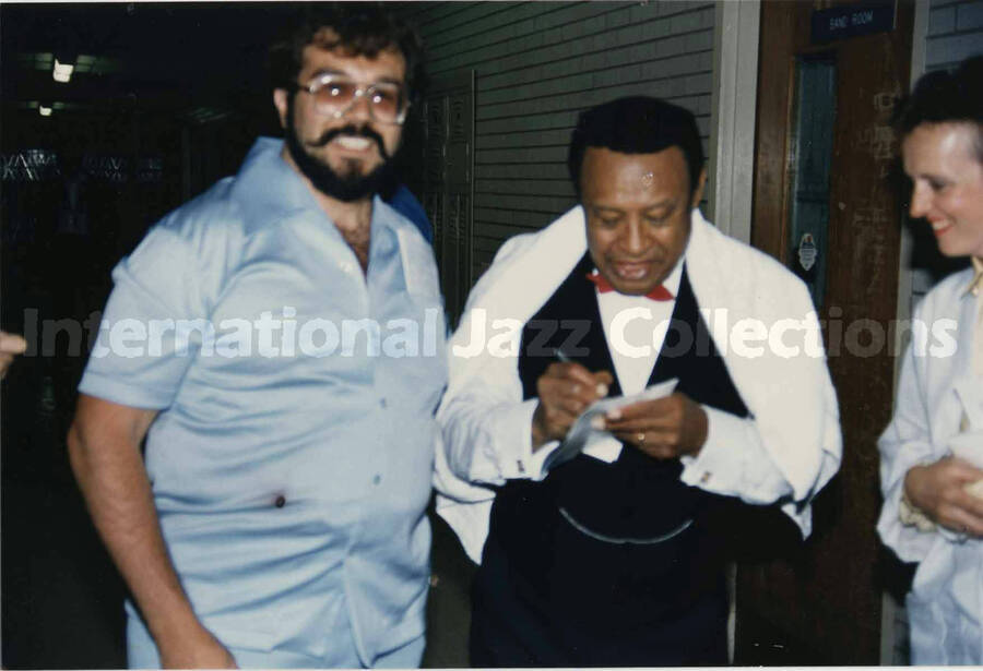 4 x 6 inch photograph. Lionel Hampton signs autograph. Dedication on the back of the photograph: Lionel, this in appreciation to good music heard on June 2 '85 in Huntington H.S. in Huntington, New York, to relight the Fire Island light in '86. With the best from an appreciative fan, Thomas Gugliotta