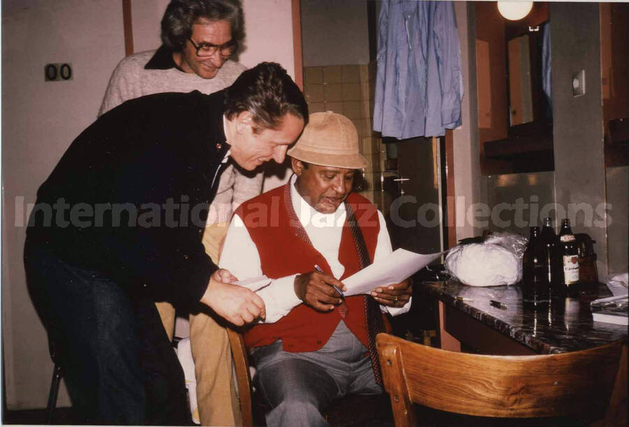 3 1/2 x 5 inch photograph. Lionel Hampton, Bill Titone, and an unidentified man