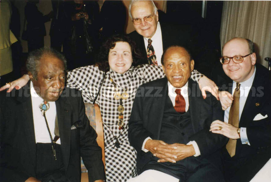 4 x 6 inch photograph. Lionel Hampton with Judge Milt Hinton and unidentified persons at a reception