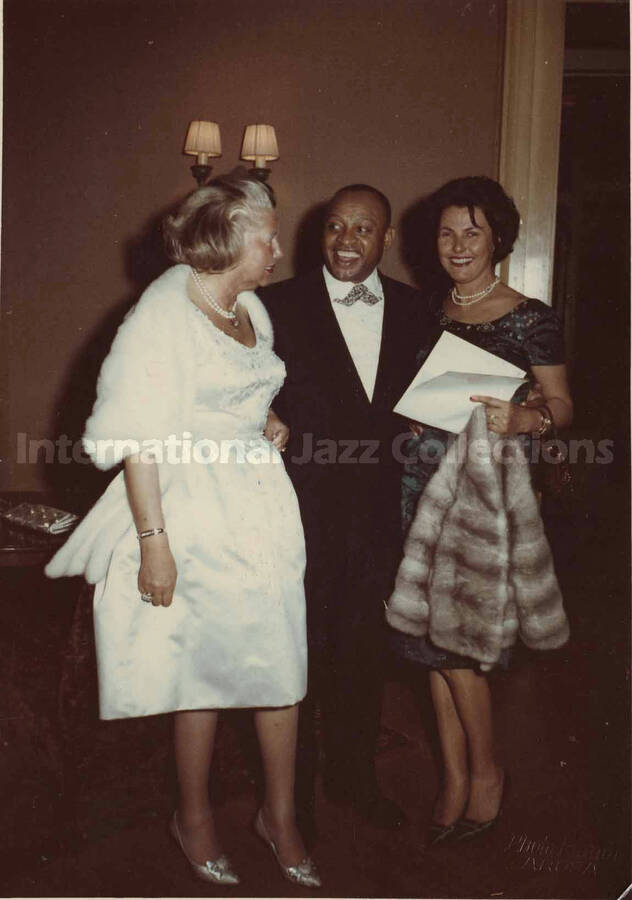 5 1/2 x 4 inch signed photograph. Lionel Hampton posing with two unidentified women, in Germany. This photograph is dedicated to Lionel Hampton from Anika, Jessika, and Hayo Breckwoldt