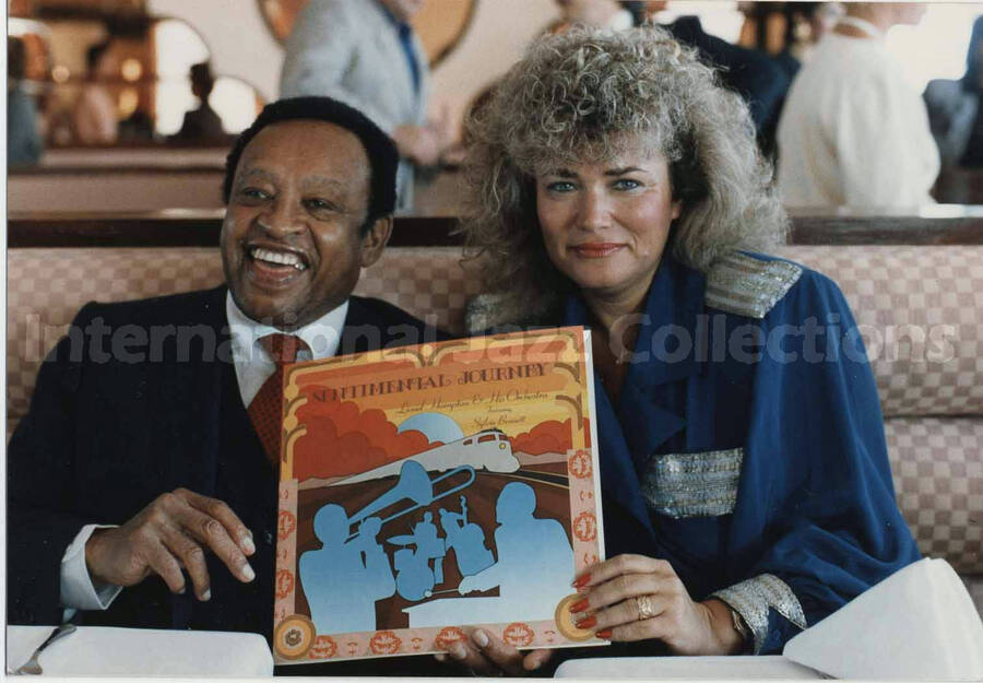 3 1/2 x 5 inch photograph. Lionel Hampton holds LP album Sentimental Journey with Sylvia Bennett