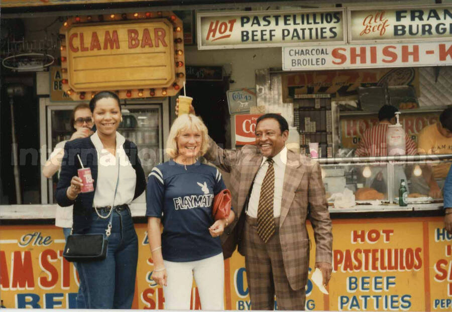 3 1/2 x 5 inch photograph. Lionel Hampton stands outside the Clam Bar with two unidentified women