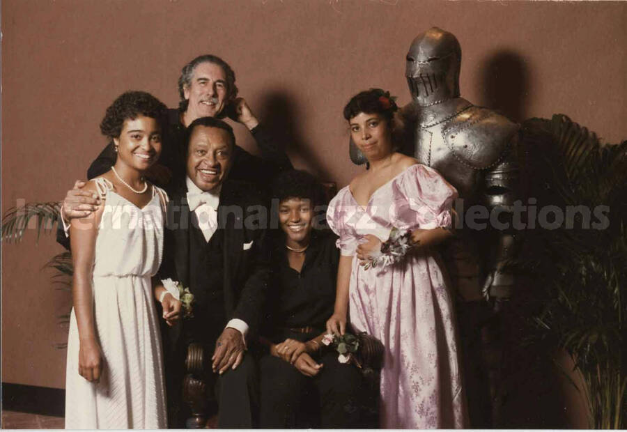3 1/2 x 5 inch photograph. Lionel Hampton poses with unidentified persons