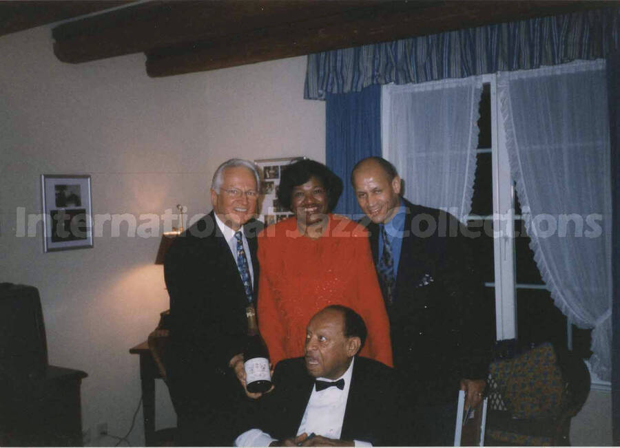 3 1/2 x 5 inch photograph. Lionel Hampton poses with three unidentified people