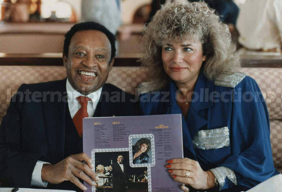 3 1/2 x 5 inch photograph. Lionel Hampton holds LP album Sentimental Journey with Sylvia Bennett
