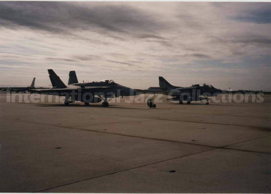 3 1/2 x 5 inch photograph. Two fighter planes on a landing strip