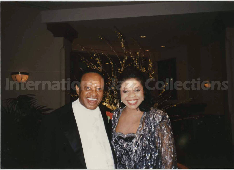 3 1/2 x 5 inch photograph. Lionel Hampton with unidentified woman at a wedding dinner