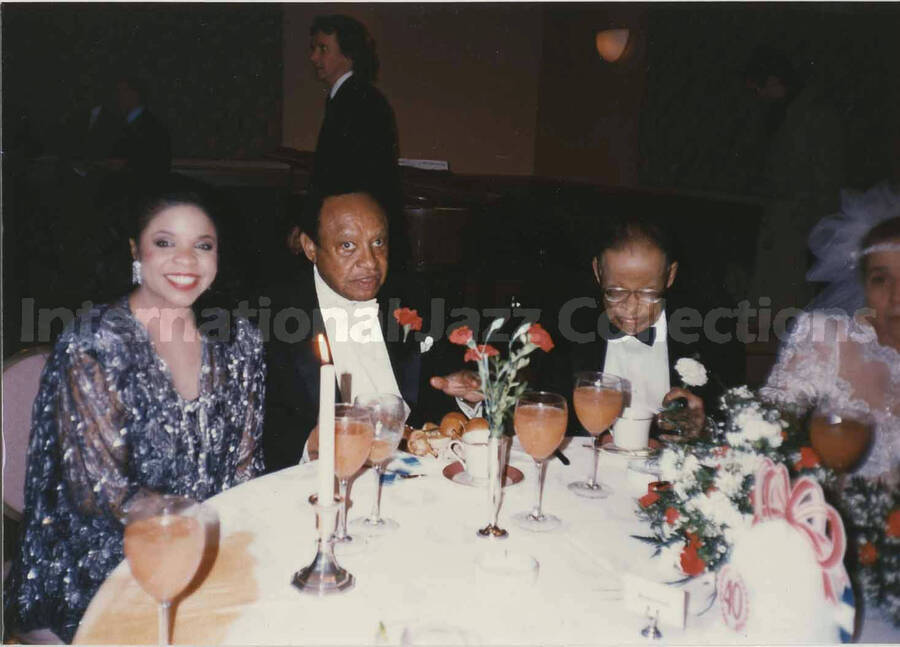 3 1/2 x 5 inch photograph. Lionel Hampton with unidentified woman at a wedding dinner