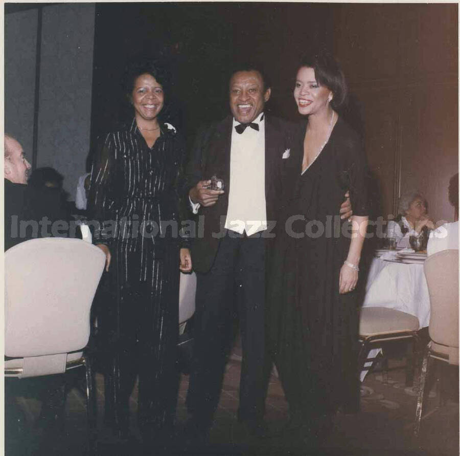 3 1/2 x 3 1/2 inch photograph. Lionel Hampton with Pat Williams, left, and Jewel Jackson McCabe, right, in a ceremony at the Garden City Hotel